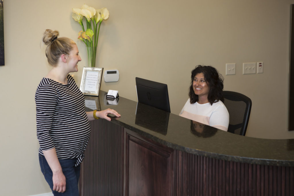patient being greeted at the front desk of powell family dental, a dentist office in powell wyoming