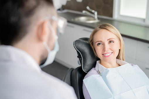 patient sitting in dental chair smiling
