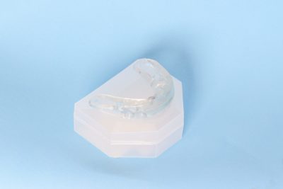 clear mouthguard on a blue background