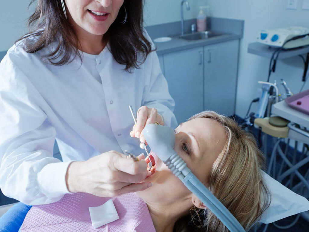 picture of woman receiving sedation in dental chair